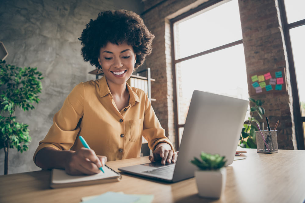 Image of professional woman working from a workstation at home.