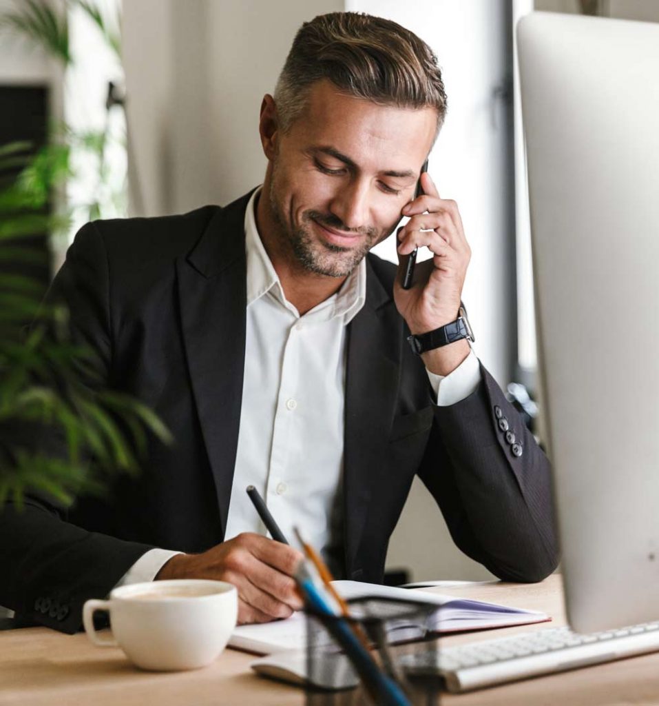 Image of businessman working at his desk, COVID-19 recovery and restructuring.