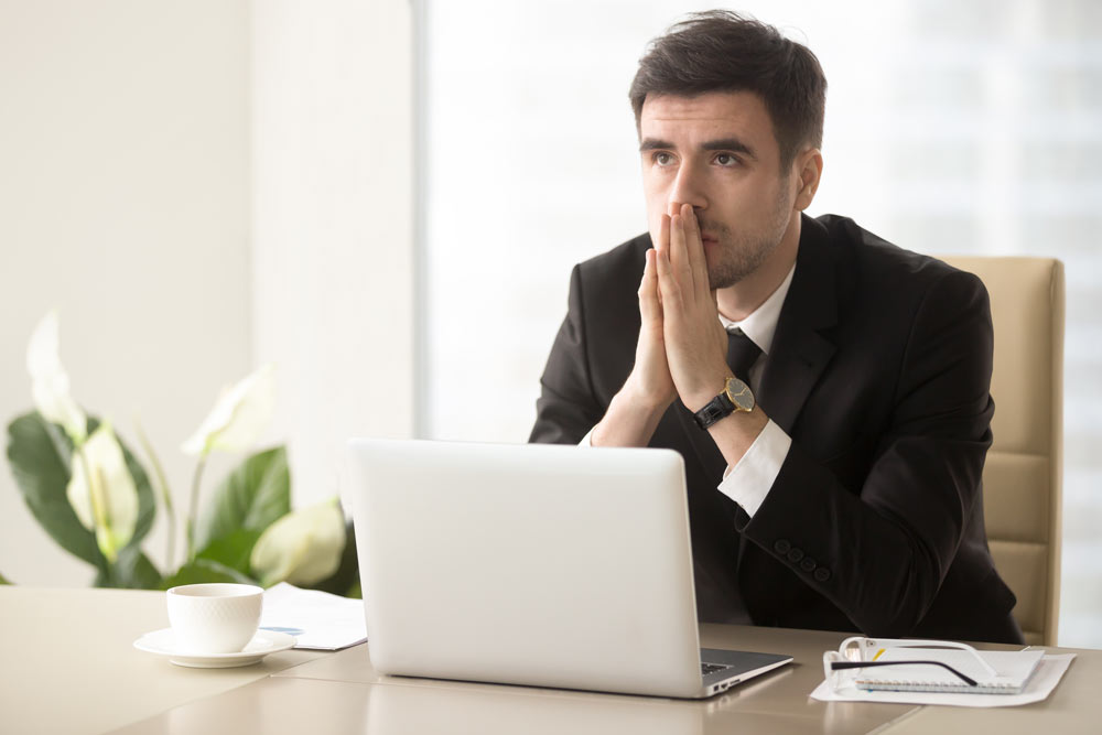 Image of CEO at his desk, worried about threats of cyberattack