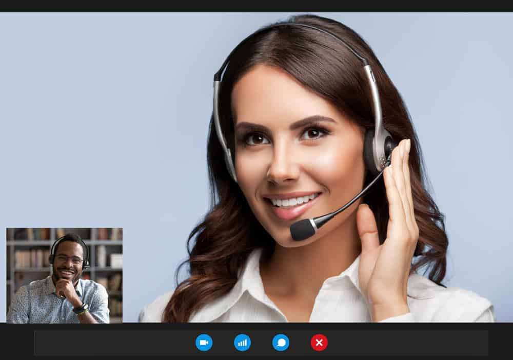 Woman chatting with co-worker on an advanced VoIP phone system.